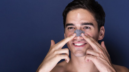 Adult male applying skin care product