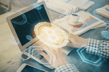 Blockchain theme hologram with man working on computer on background. Concept of crypto chain....