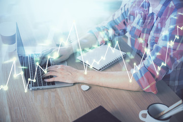 Multi exposure of forex graph with man working on computer on background. Concept of market analysis.