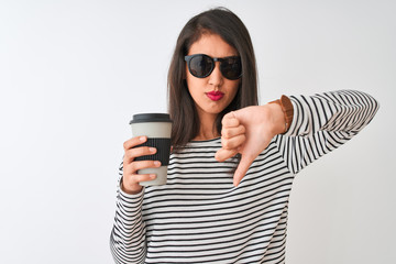 Chinese woman wearing sunglasses drinking take away coffee over isolated white background with...