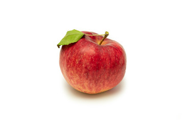 Ripe red apple with apple leaf. Isolated on a white background.