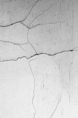 Abstract background. Damaged wall with traces of destruction. Rough and uneven surface of an old building.