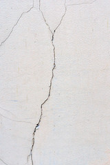 Obraz premium Abstract background. Damaged wall with traces of destruction. Rough and uneven surface of an old building.