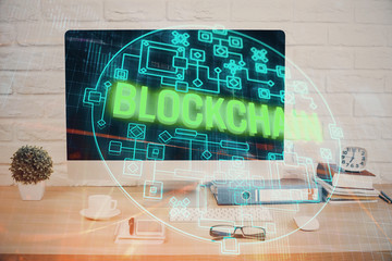 Double exposure of blockchain and crypto economy theme hologram and table with computer background....