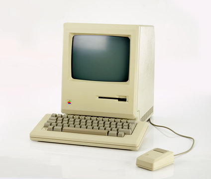 Aachen, Germany - March 14, 2014: Studioshot of an original Macintosh 128k called Apple Macintosh on white background. This was the first produced Mac, released on january 1984