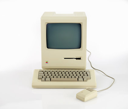 Aachen, Germany - March 14, 2014: Studioshot of an original Macintosh 128k called Apple Macintosh on white background. This was the first produced Mac, released on january 1984