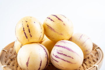Fresh fruit ginseng fruit on a bamboo plate on white background
