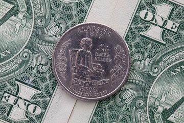 Symmetric composition of US dollar bills and a quarter of Alabama.