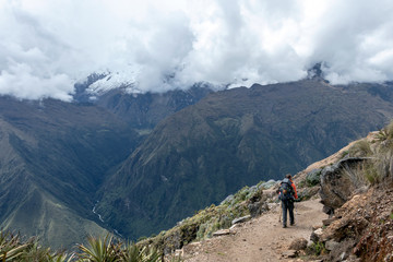 Young hiker man trekking with backpack in Peruvian Andes mountains, Peru, South America