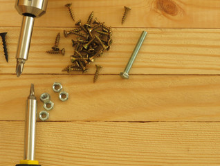 Set of tools. Drill, screws, screwdriver, pliers. Wood background.