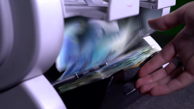 Male, female hand pulls out shekels IS from money counter machine. Bill. Currency, detector counting.