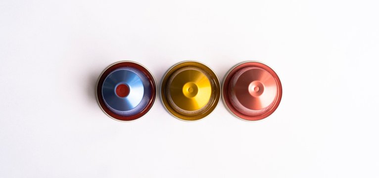 Three Espresso Capsules Top View isolated on white background.