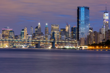 Fototapeta na wymiar Manhattan bridge Brooklyn Bridge and Financial District at sunrise with long exposure