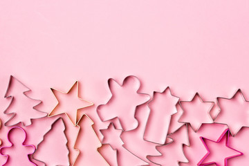 Fototapeta premium Forms for Christmas Biscuits Forms for Christmas Cookies Sweet Christmas Background Horizontal Pink Background