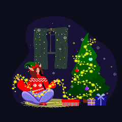 Cosy Xmas atmosphere at the Christmas Eve. Alone happy girl lisening music, having relaxation with her cat.