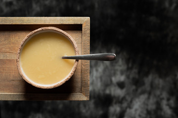 bowl of hot soup on a wooden tray