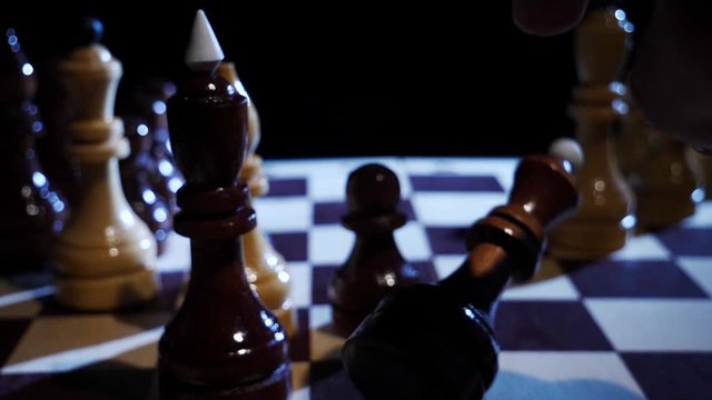 Piece of Queen falls on the chessboard in slow motion