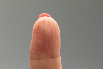 An extreme closeup and macro detailed view on the palmer side of a person's forefinger, with heavy...