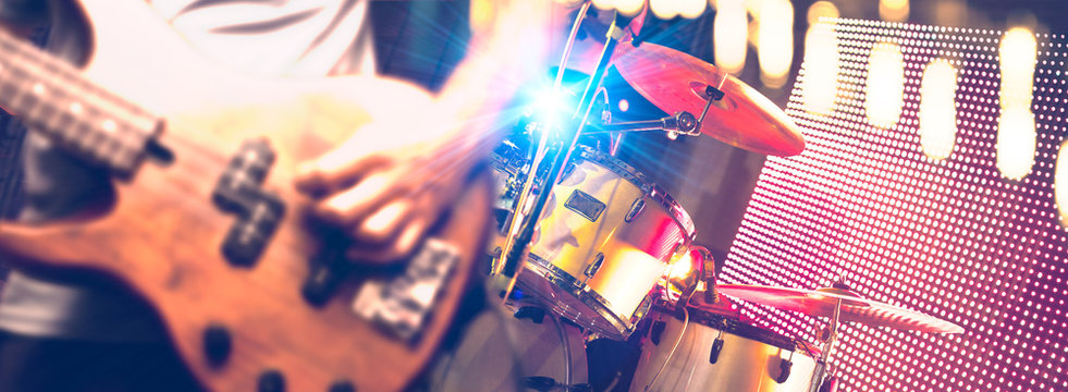 Live music and band performer.Bassist and drum in the stage.Night entertainment and leisure.Pop and rock band in concert - Powered by Adobe