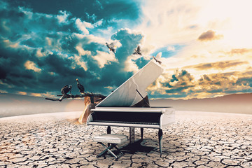 Piano in nature.Surreal image related to piano music,song and melody.Sunset and dry soil scenic landscape.Birds and cracked floor © C.Castilla