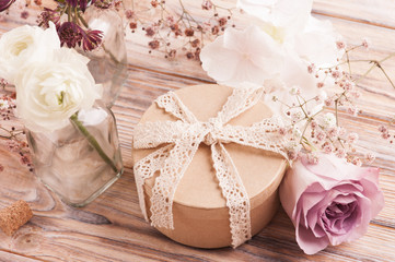 White ranunculus and rose with gift box