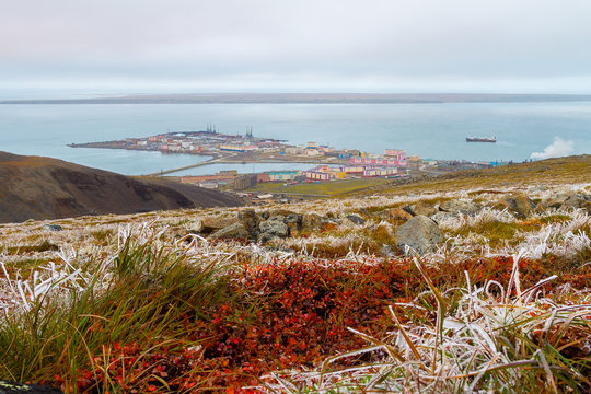 View from the hills to the port town on the coast of the Arctic Ocean. Pevek is the northernmost city in Russia. Frosts in August in the Arctic tundra. Pevek, Chukotka, Polar Siberia, Russian Far East