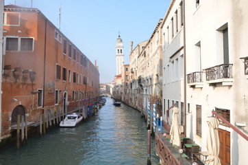 Fototapeta na wymiar Old buildings along a narrow canal in Venice