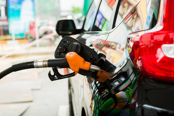 Refilling the black car with fuel at the gas station,  Refilling the car with fuel at the refuel station, The concept of fuel energy.