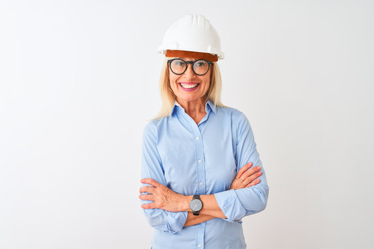 Middle age architect woman wearing glasses and helmet over isolated white background happy face smiling with crossed arms looking at the camera. Positive person.