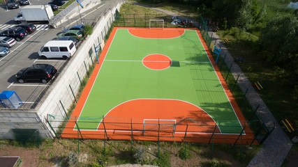 Soccer field among tall houses.