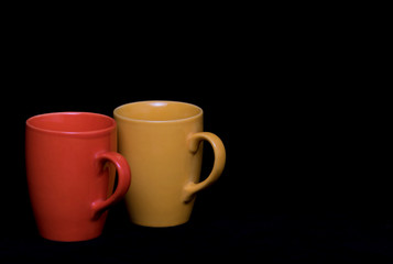 Isolated set of colourful coffee mugs on a black background