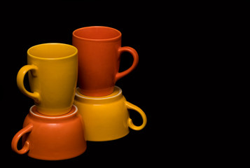 Isolated set of colourful coffee mugs on a black background