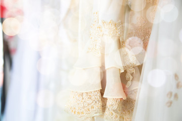 Close up blurred bokeh beautiful wedding dress in fitting room workplace, wedding concept