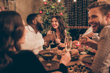 Portrait of nice attractive smart stylish well-dressed cheerful cheery excited positive glad guys spending fest festive evening greetings congrats served table in decorated house indoors