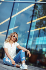 Fashion portrait of a young woman in white sunglasses