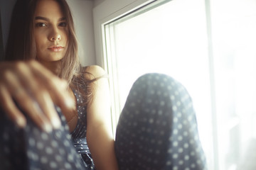 Young romantic girl by the window