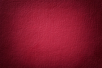 Dark red leather texture background. Closeup photo.