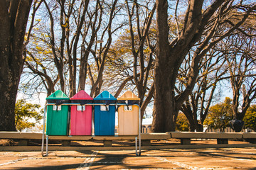 Selective collection bins ( lixeiras - coleta seletiva de lixo ) in public square in urban military...