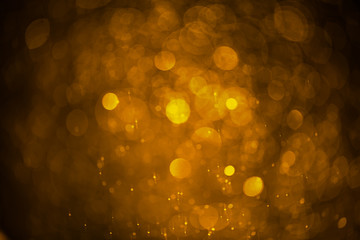 Abstract blurred background of golden water droplets bokeh with light effect