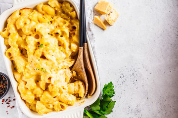 Mac and cheese in the oven dish, white background. American food concept.