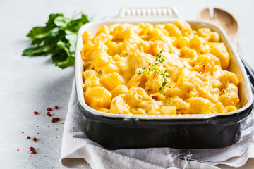 Mac and cheese in the oven dish, white background. American food concept.