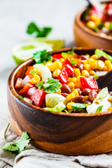 Traditional corn bean mexican salad in a wooden bowl. Mexican food concept.