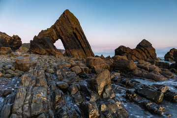 View of Blackchurch Rock at Mouthmill Beach, North Devon, England at sunrise