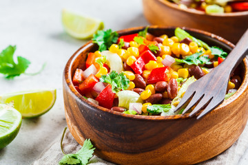 Traditional corn bean mexican salad in a wooden bowl. Mexican food concept.