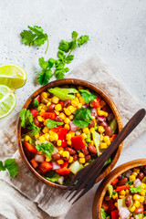 Traditional corn bean mexican salad in a wooden bowl. Mexican food concept.