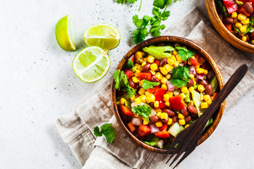 Traditional corn bean mexican salad in a wooden bowl. Mexican food concept.