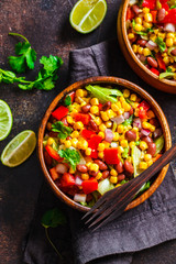 Traditional corn bean mexican salad in a wooden bowl. Mexican food concept.