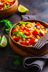 Traditional corn bean mexican salad in a wooden bowl. Mexican food concept.
