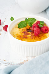Crema catalana, Spanish dessert with berries in white ramekin, vertical