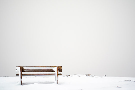 lonely wooden bench in an icy environment
